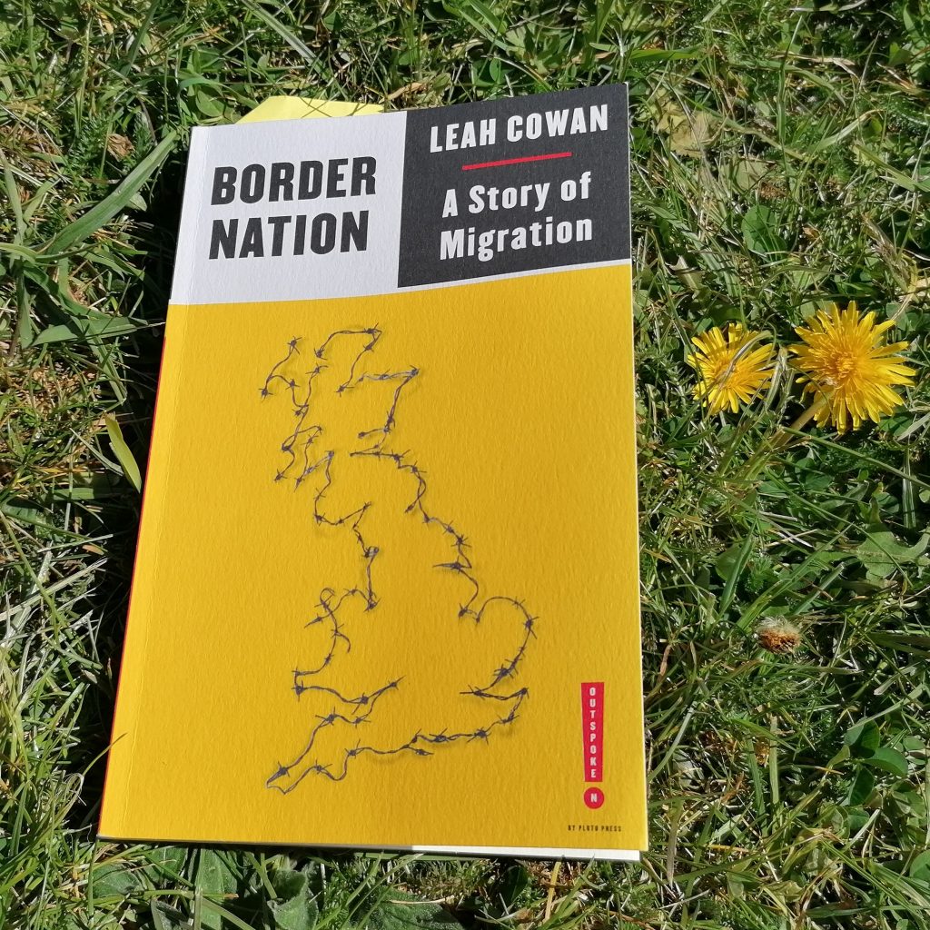 A copy of Border Nation lying on the grass