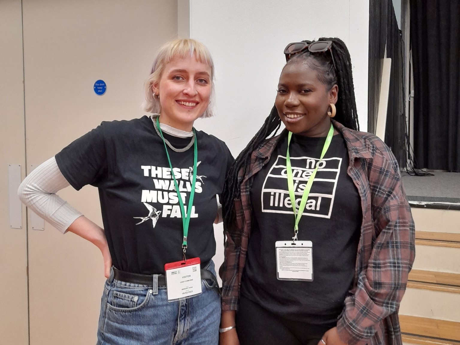 Leah and Fatou smiling in Right to Remain T-shirts at the conference