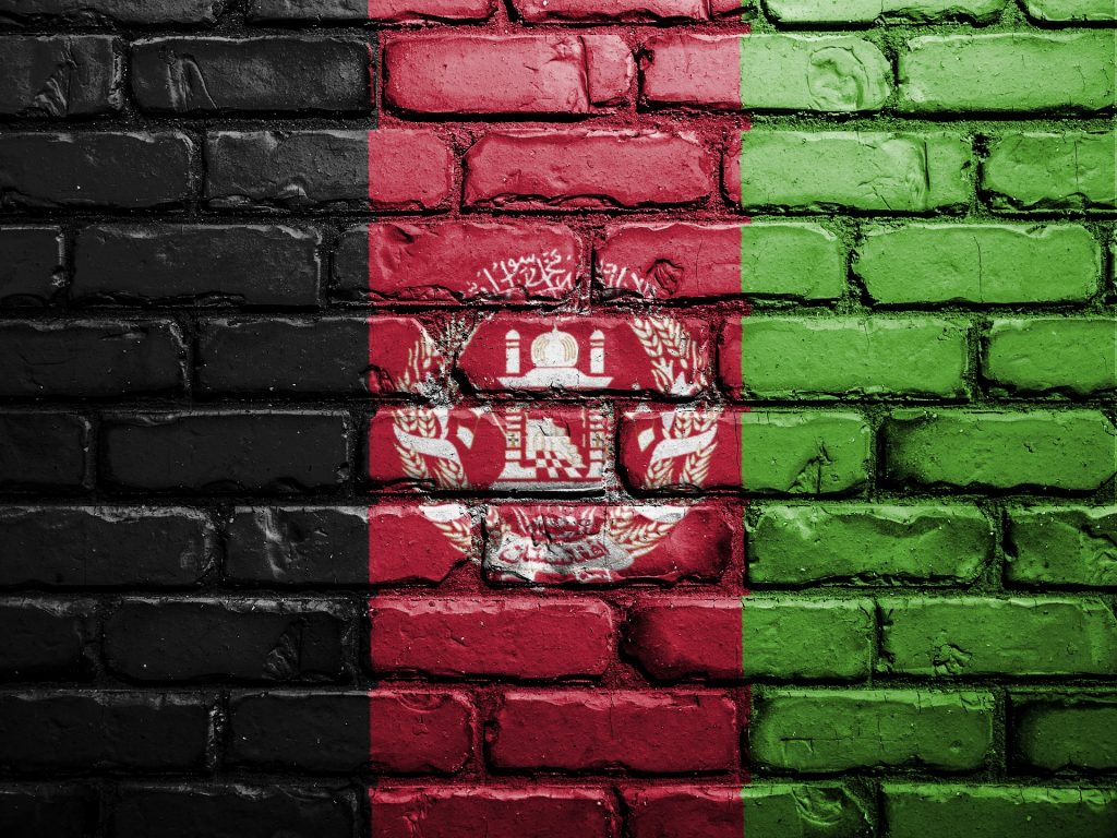 The black, red and green Afghan flag painted onto a brick wall