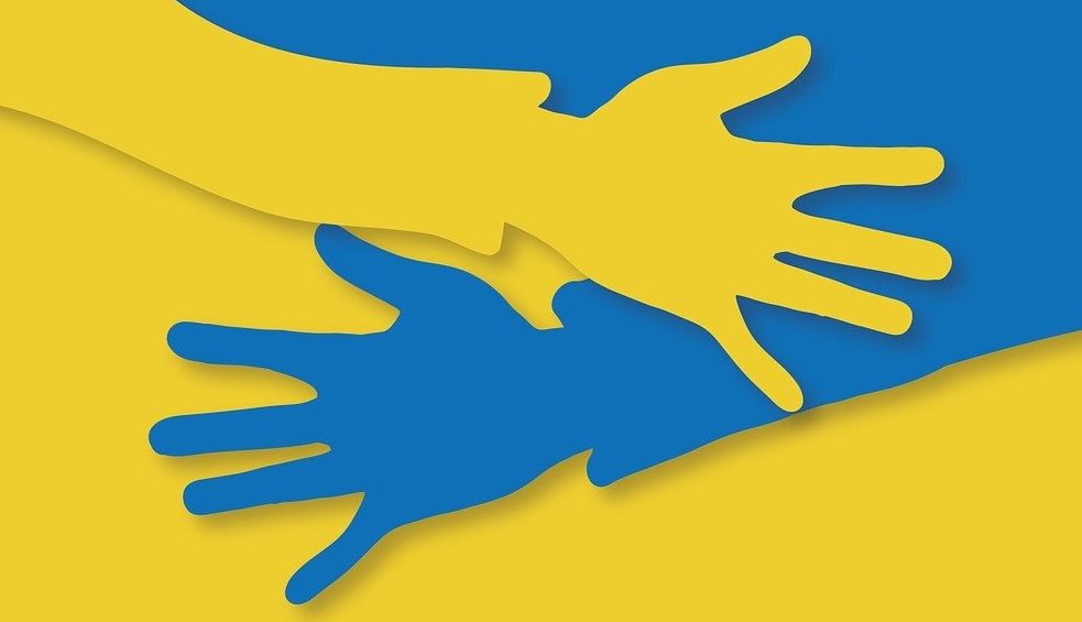 the Ukrainian flag presented as a yellow hand and a blue hand embracing