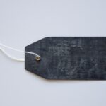 a blank, black name tag with white string